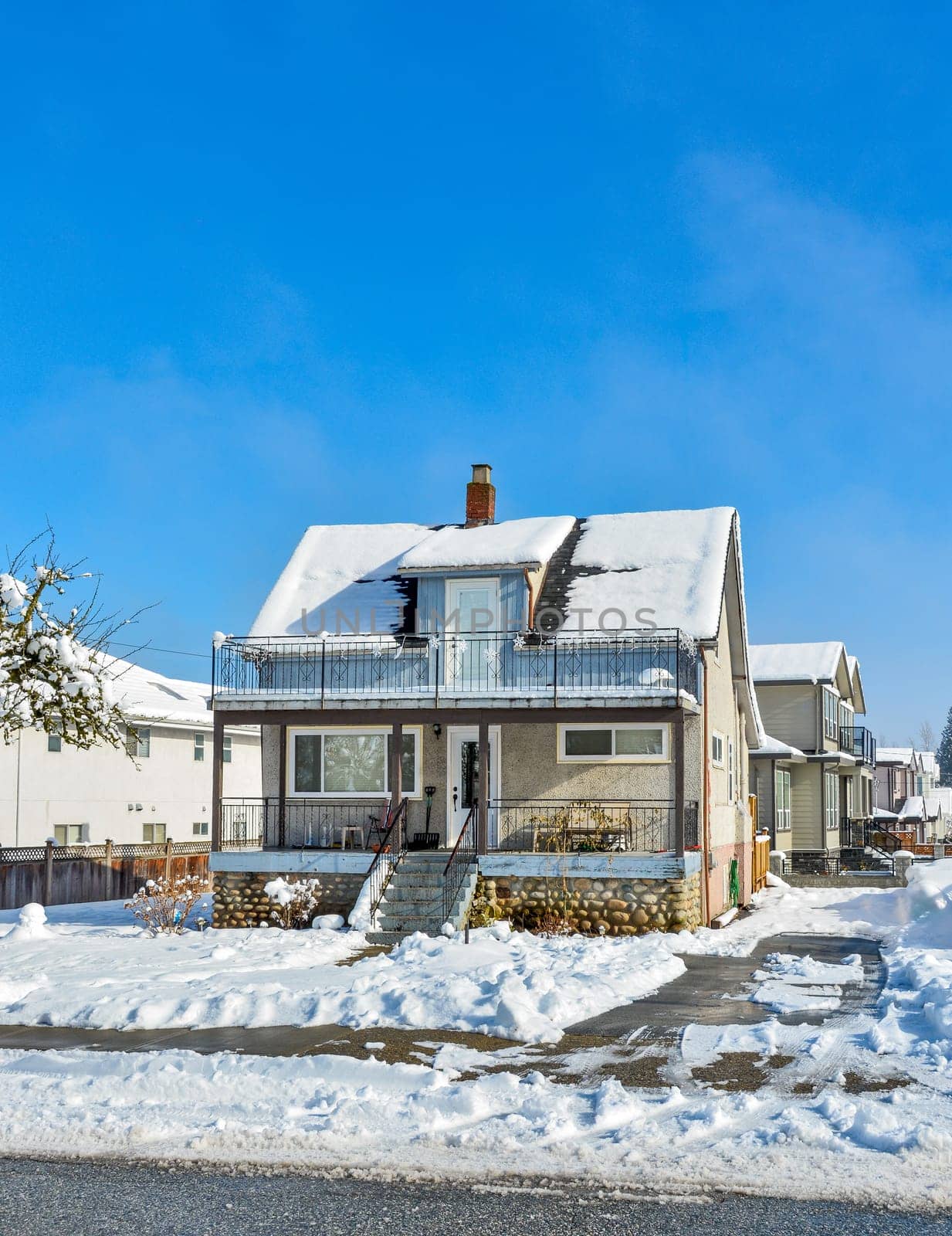 Small old family residential house on sunny winter day in Canada.