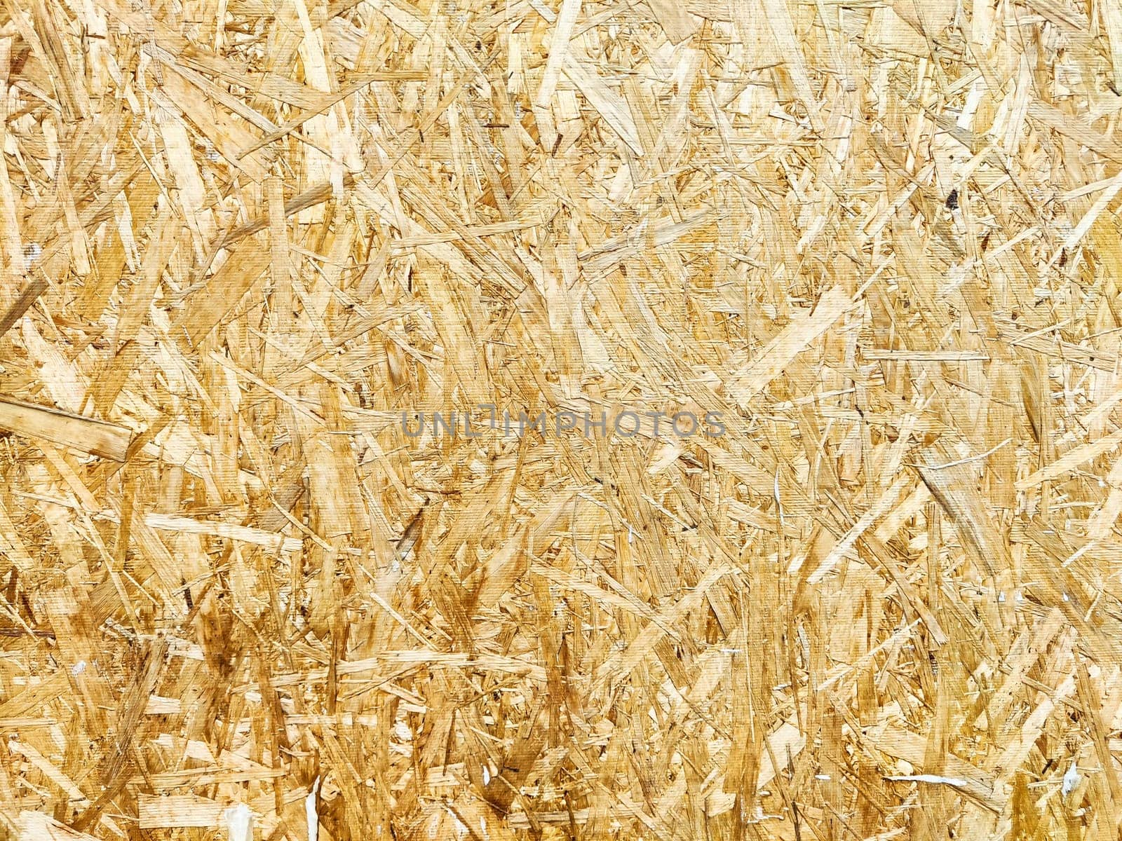 Close-up view of light wood fiber board showcasing its natural texture and color ideal for design projects.
