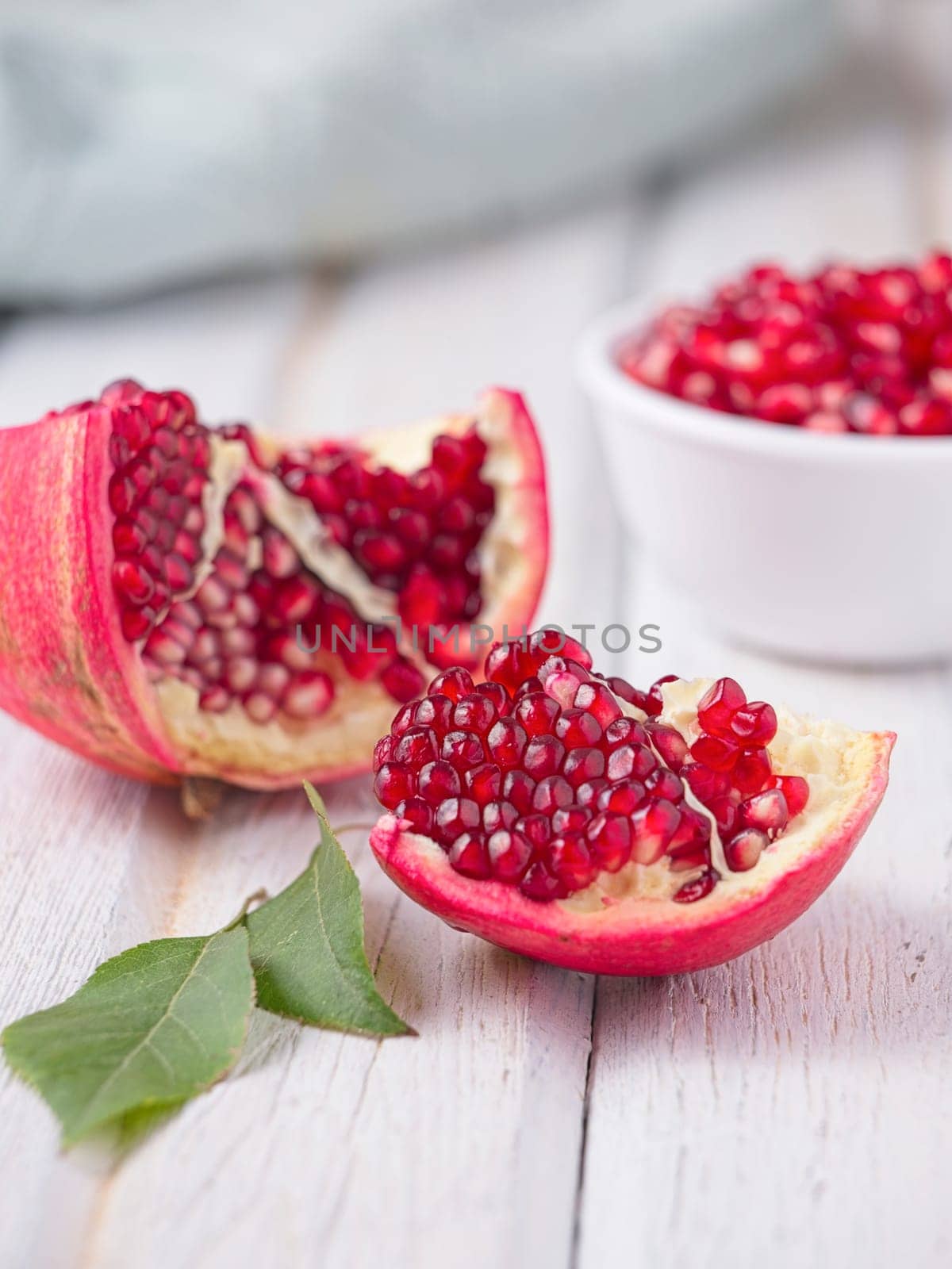 A close up vivid photo of opened pomegranates and their seeds.