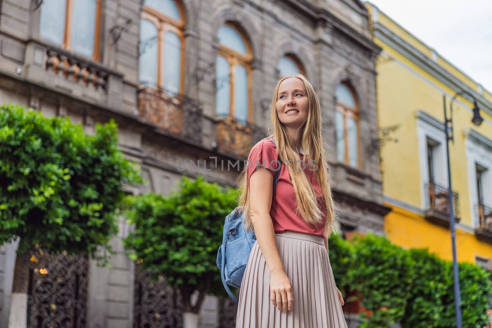Female tourist walking through the colorful colonial streets of Puebla, Mexico. Travel, cultural exploration, and vibrant architecture concept.