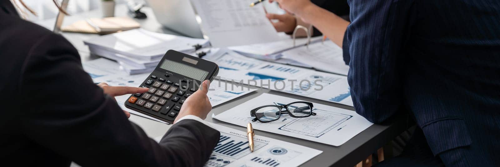 Auditor and accountant team working in office, analyze financial data and accounting record with calculator. Accounting company provide finance and taxation planning for profitable cash flow. Insight