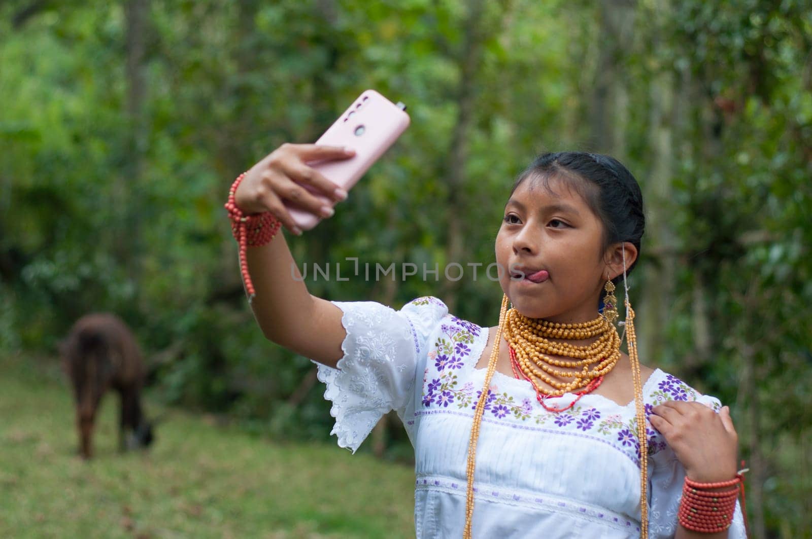 indigenous teenager from latin america sending a photo to her lover from the jungle of Ecuador with her yama . High quality photo