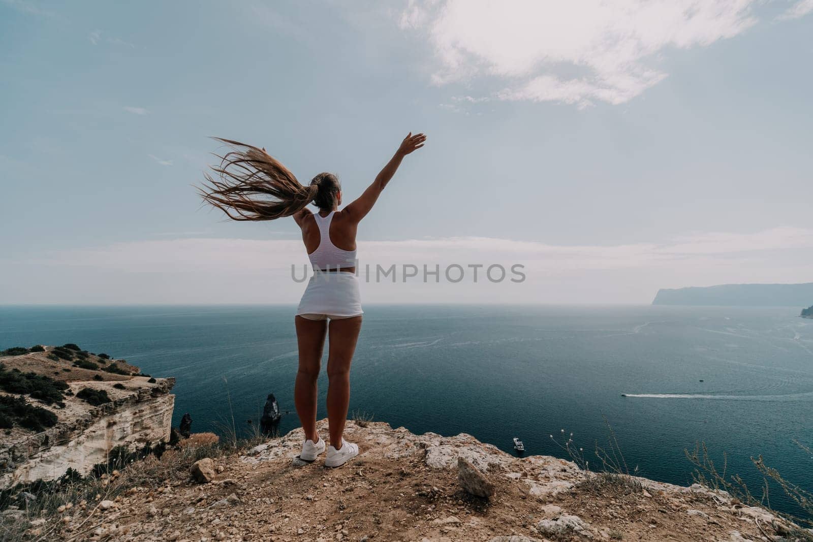 Woman sea pilates. Sporty middle-aged woman training in pilates on yoga mat by sea. concepts of health, wellness, and mindfulness in exercise, promoting the benefits of active and balanced lifestyle by panophotograph