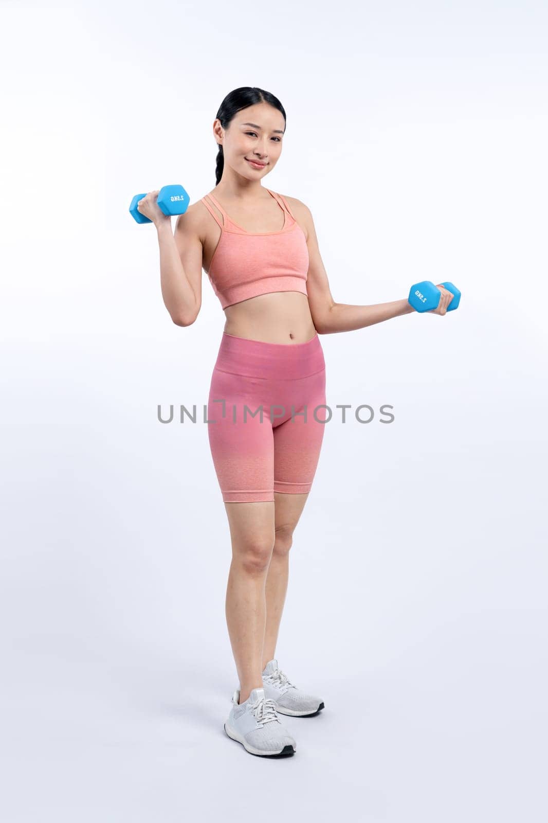 Vigorous energetic woman doing yoga with dumbbell weight exercise. by biancoblue