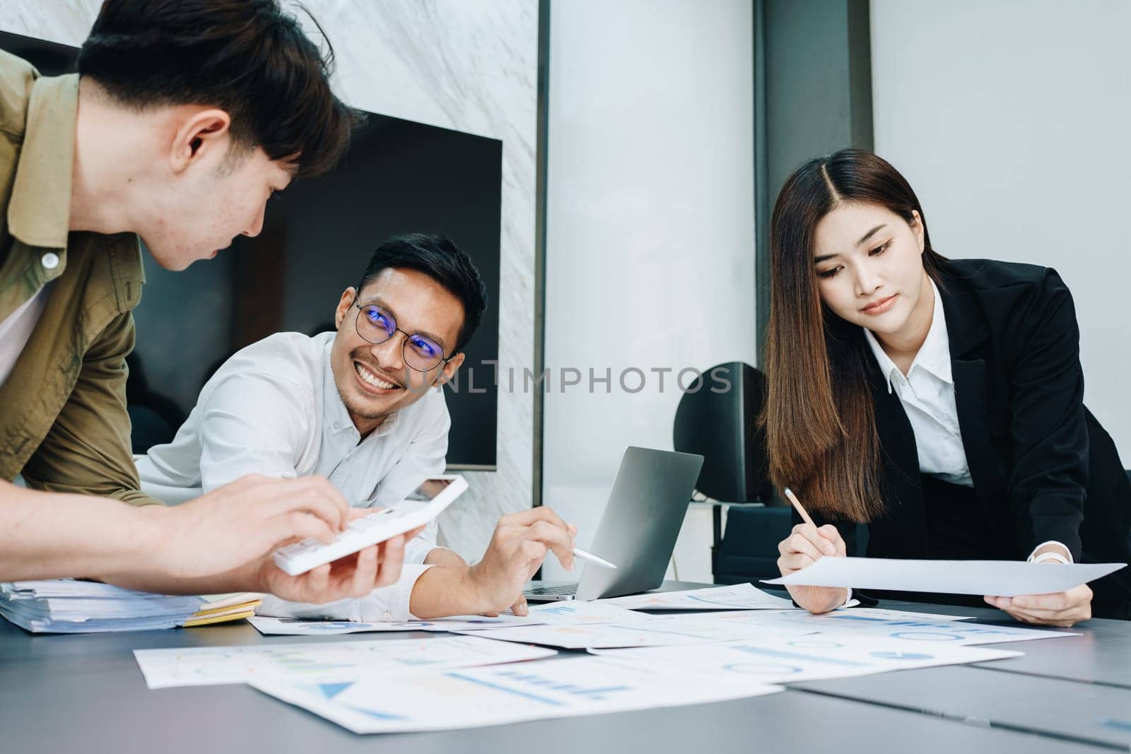 Asian business advisor meeting to analyze and discuss the situation on the financial report in the meeting room.Investment Consultant, Financial , teamwork ,brainstorming ,startup and accounting by Manastrong