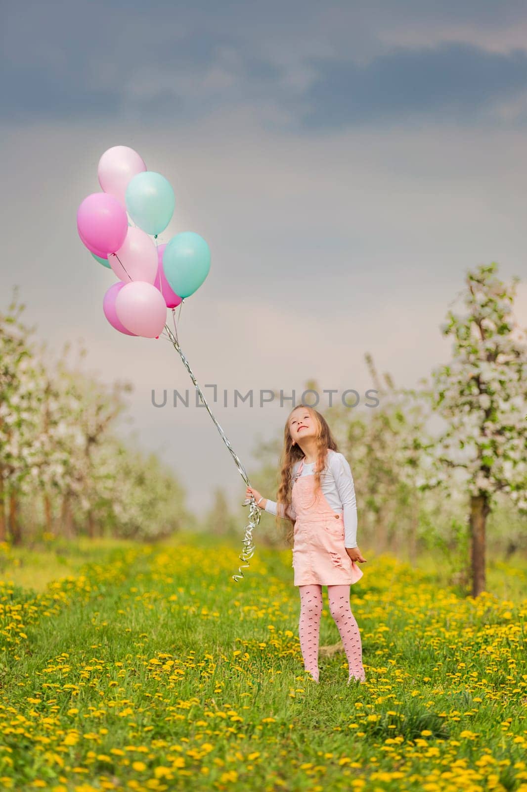 girl with balloons in a young garden by zokov