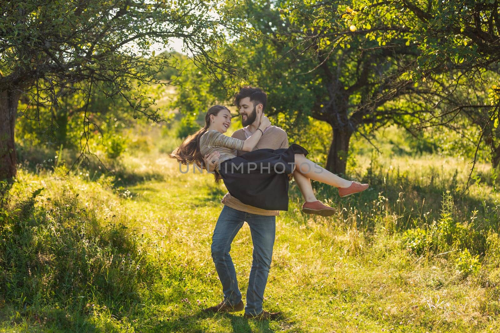 guy carries his girlfriend in his arms by zokov