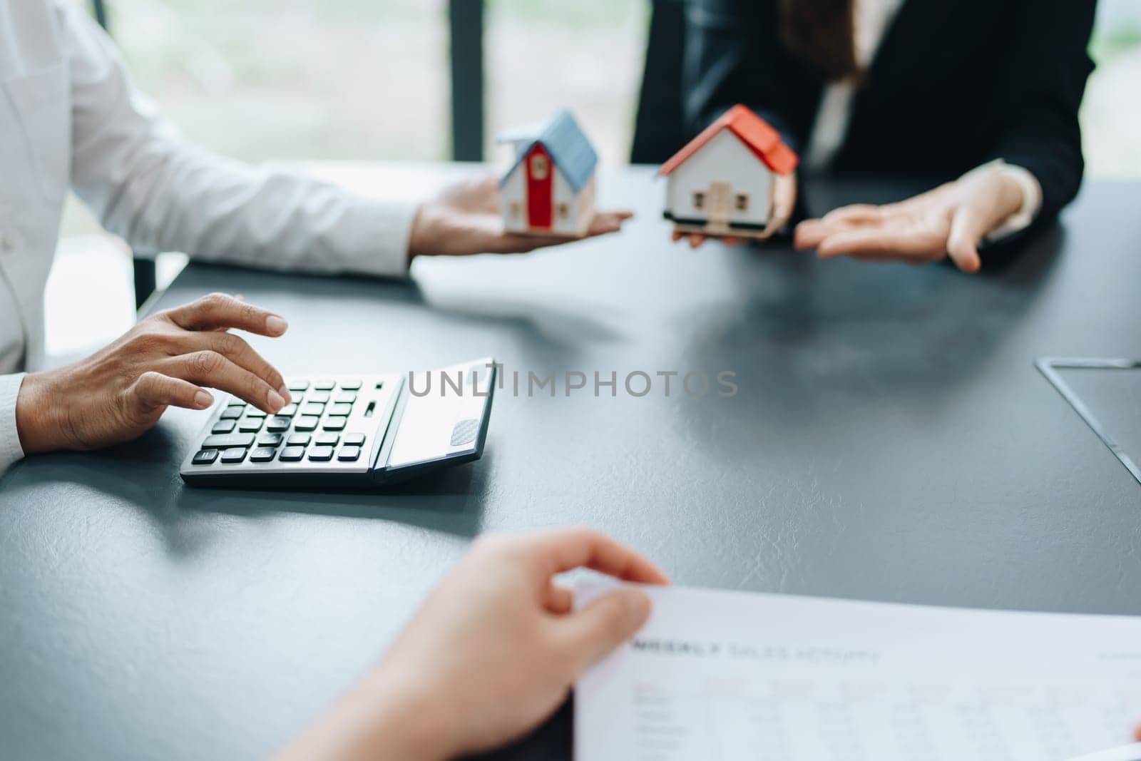 Guarantee, mortgage, agreement, contract, signed, real estate agent pointing to documents for customers to read the agreement before signing important documents by Manastrong
