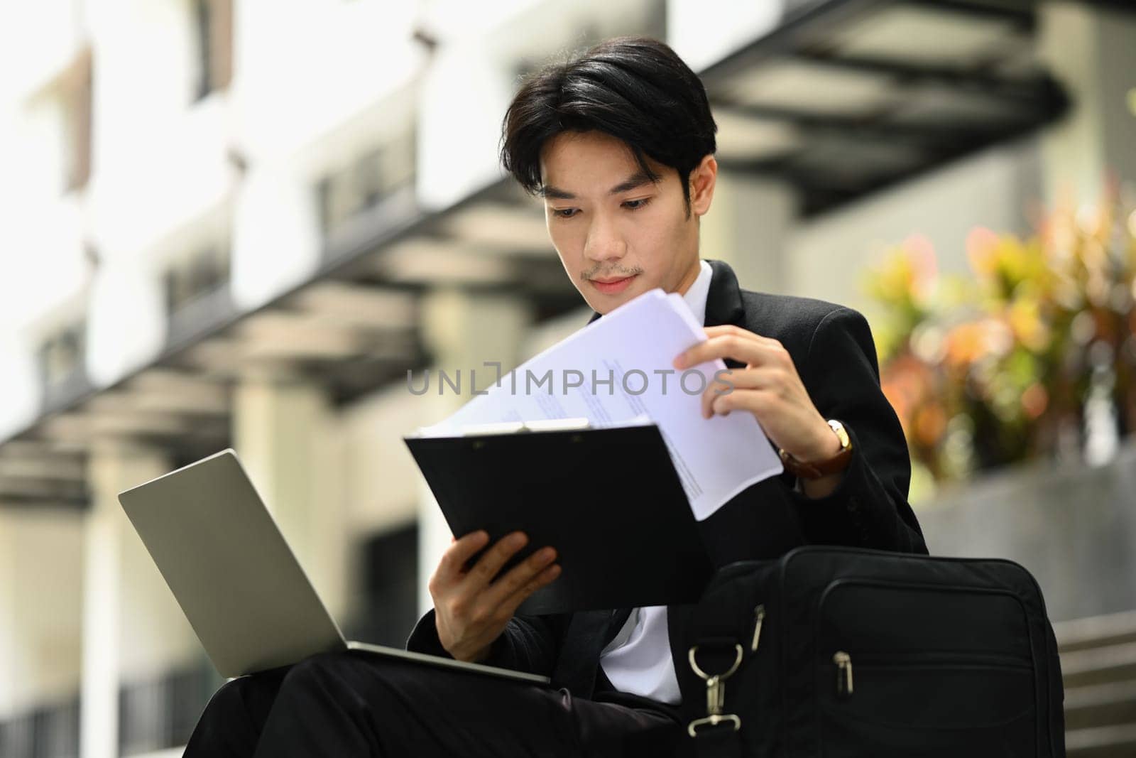 Focused businessman examining reports before going to the office. Business, technology and lifestyle.