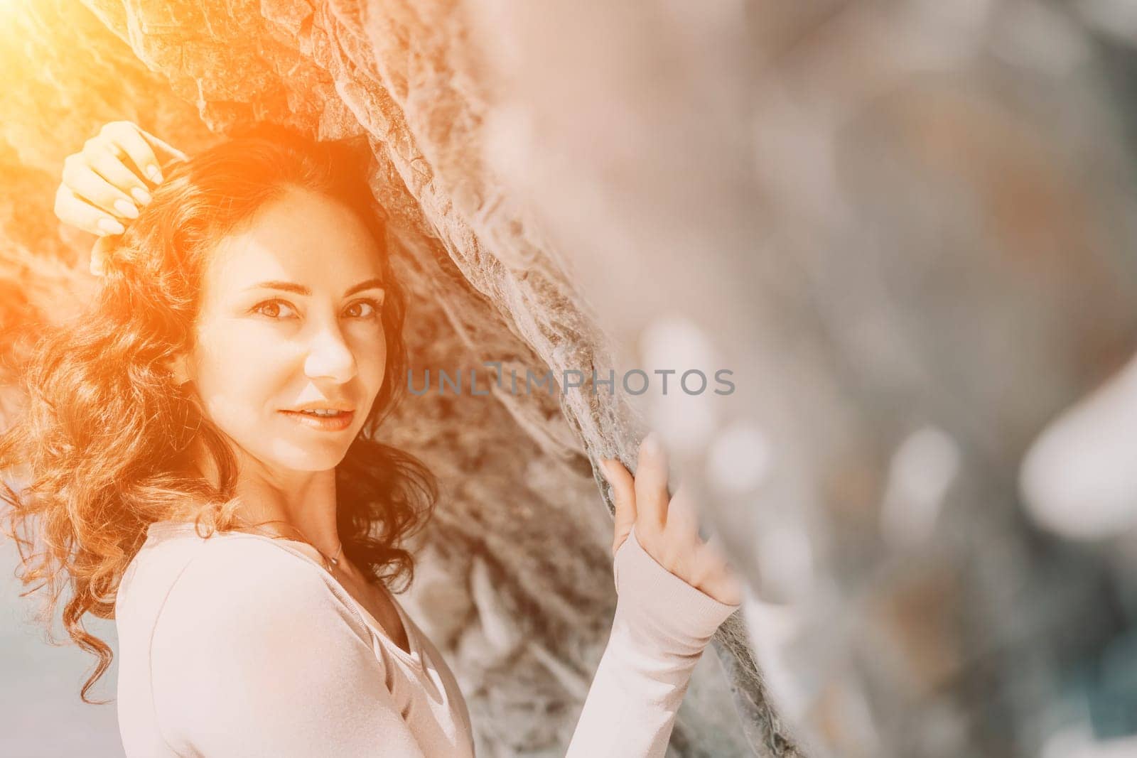 Happy young attractive brunette woman in red swimsuit, on the beach and sea background. Holiday vacation and travel concept.