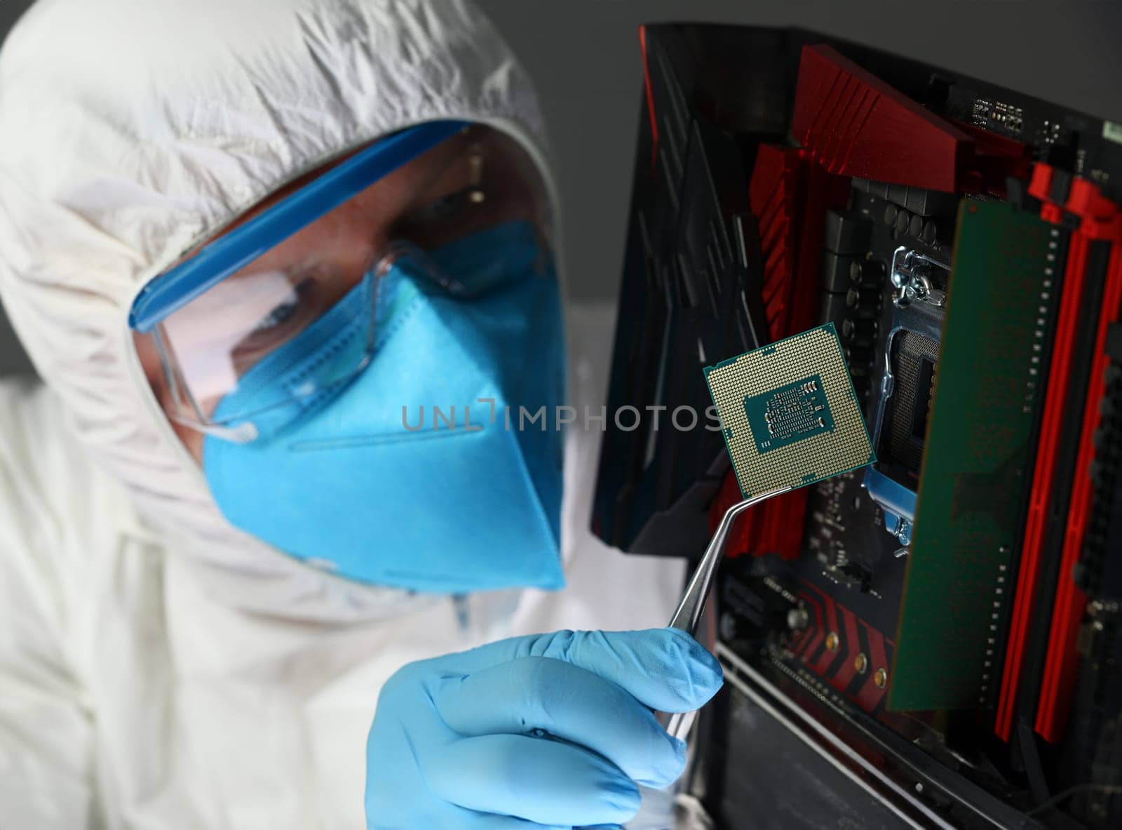 Close-up of scientist in uniform testing computer technology. Professional developer developing server. Microelectronics design. Repair and maintenance concept