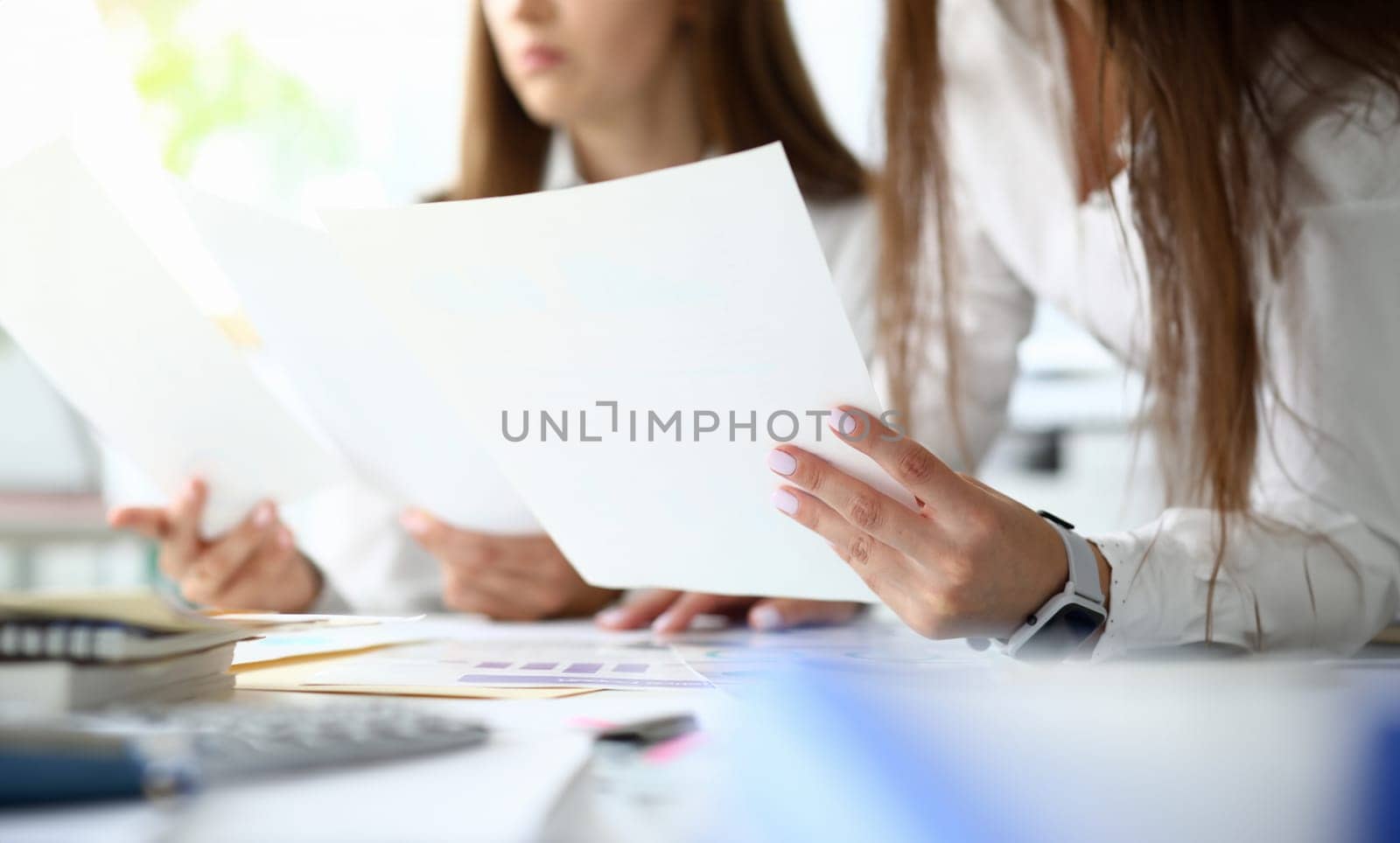 Focus on important documents with charts and graphs used for special intellectual corporation analysis of economical situation of current corporation. Accounting office concept. Blurred background