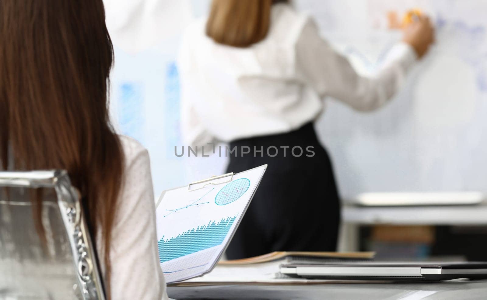 Focus on profitable charts and graphs in paper tablet used for intellectual review on economical situation of current corporation. Accounting office concept. Blurred background
