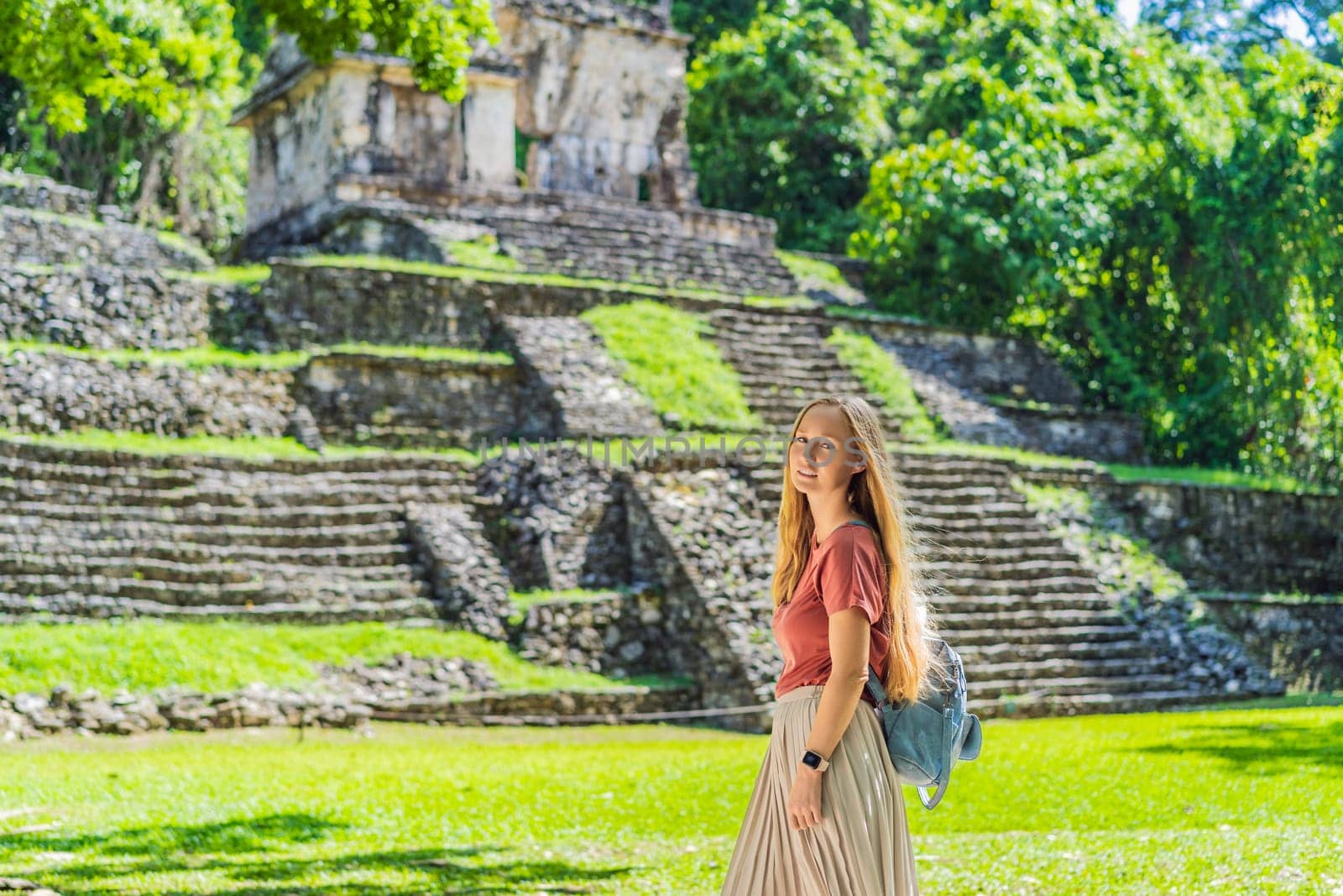 Female tourist exploring the ancient pyramids of Palenque, Mexico, surrounded by dense jungle. Cultural heritage and adventure travel concept.