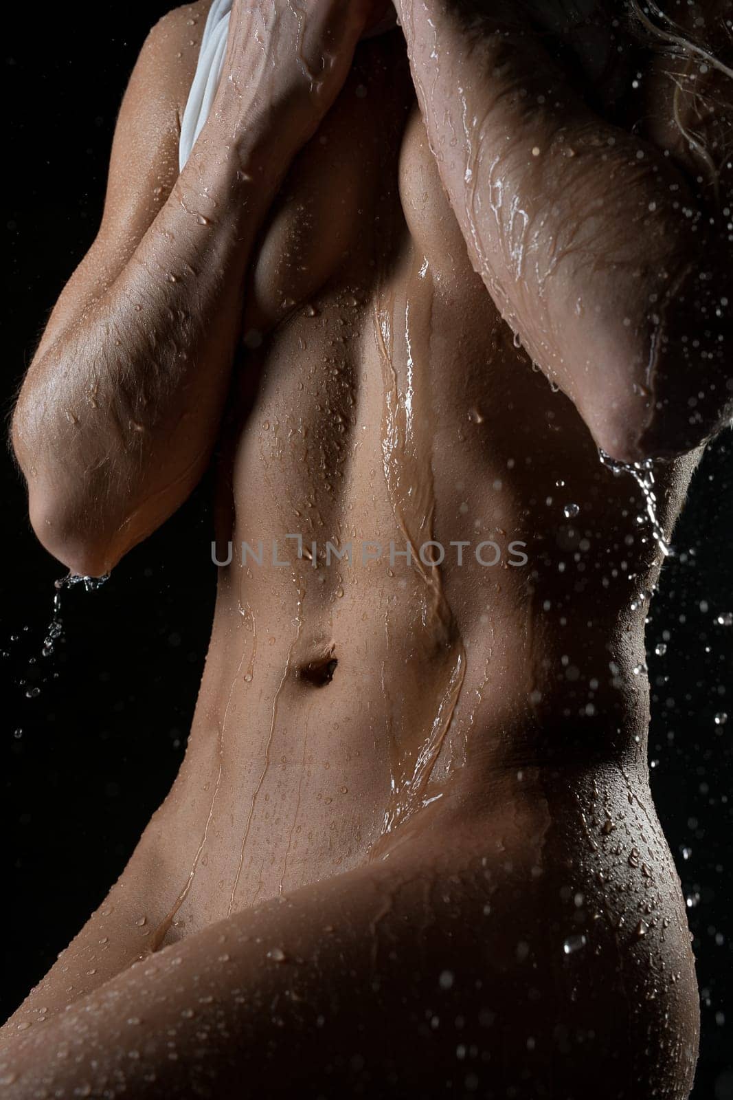 Nude slim woman body cropped shot on black backgound