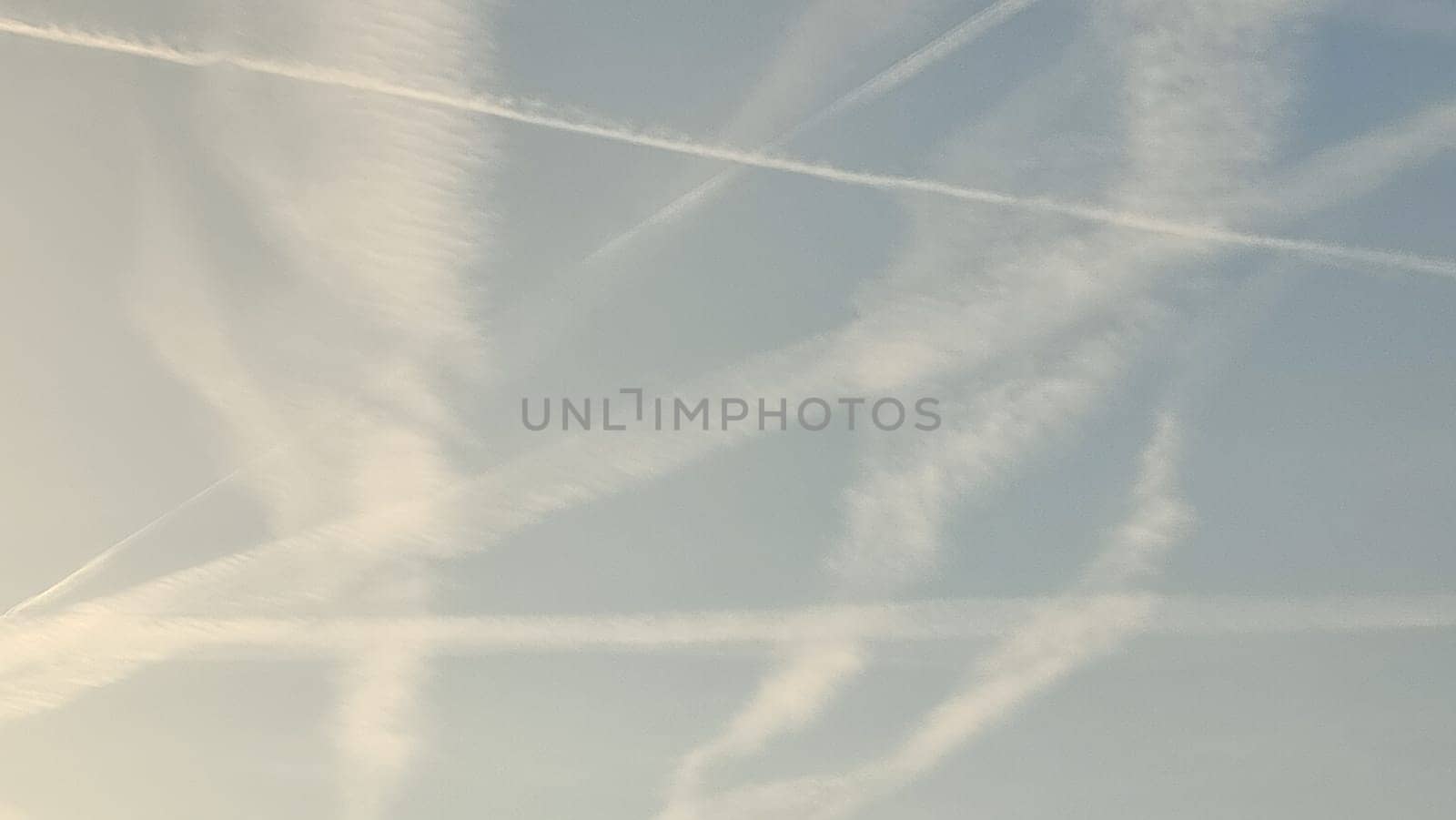 blue sky, white stripes, traces of airplane flight, air background abstract . High quality photo