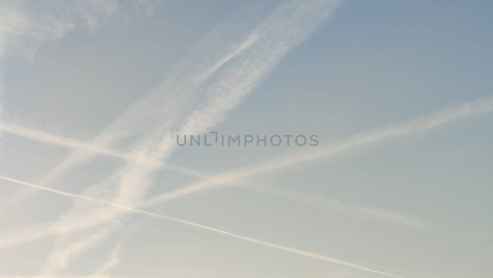blue sky, white stripes, traces of airplane flight, air background abstract . High quality photo