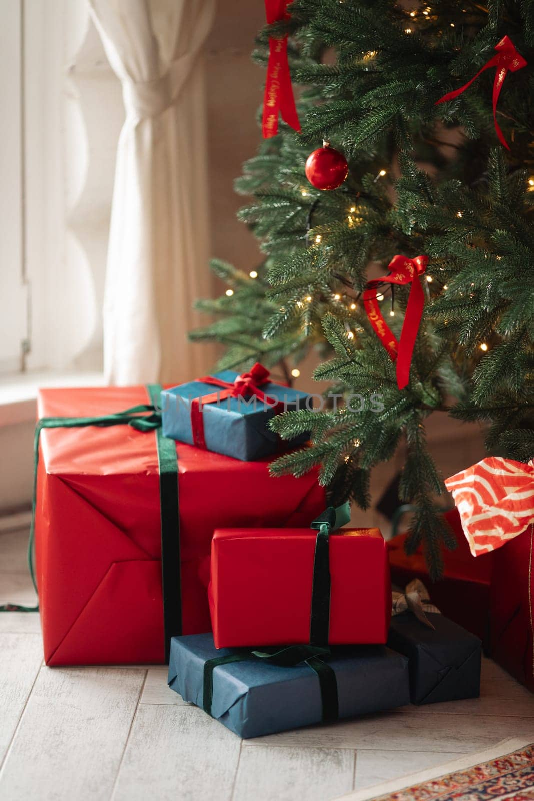gifts under the tree, lots of gift boxes. Festive mood.
