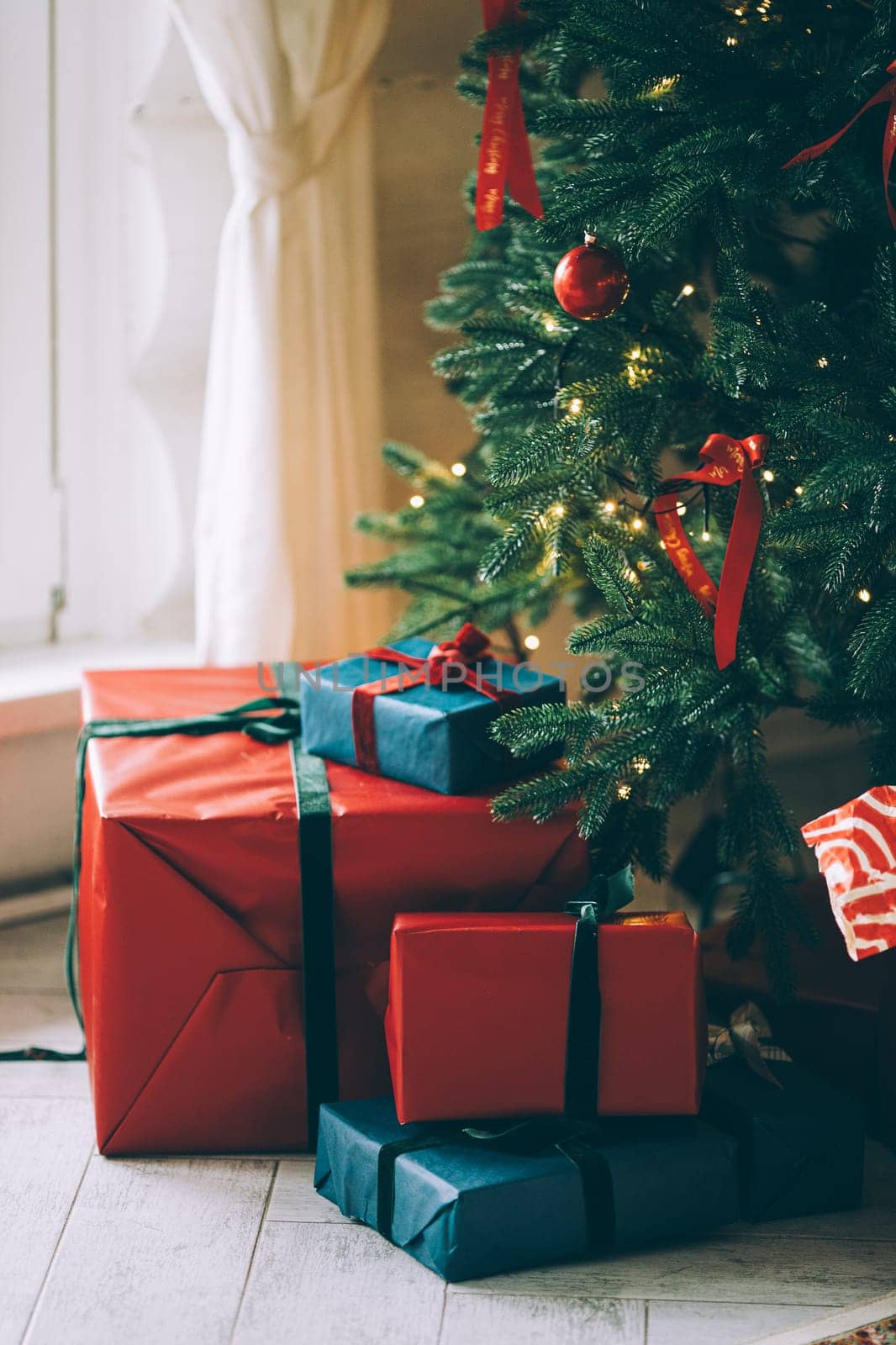 gifts under the tree, lots of gift boxes. Festive mood.