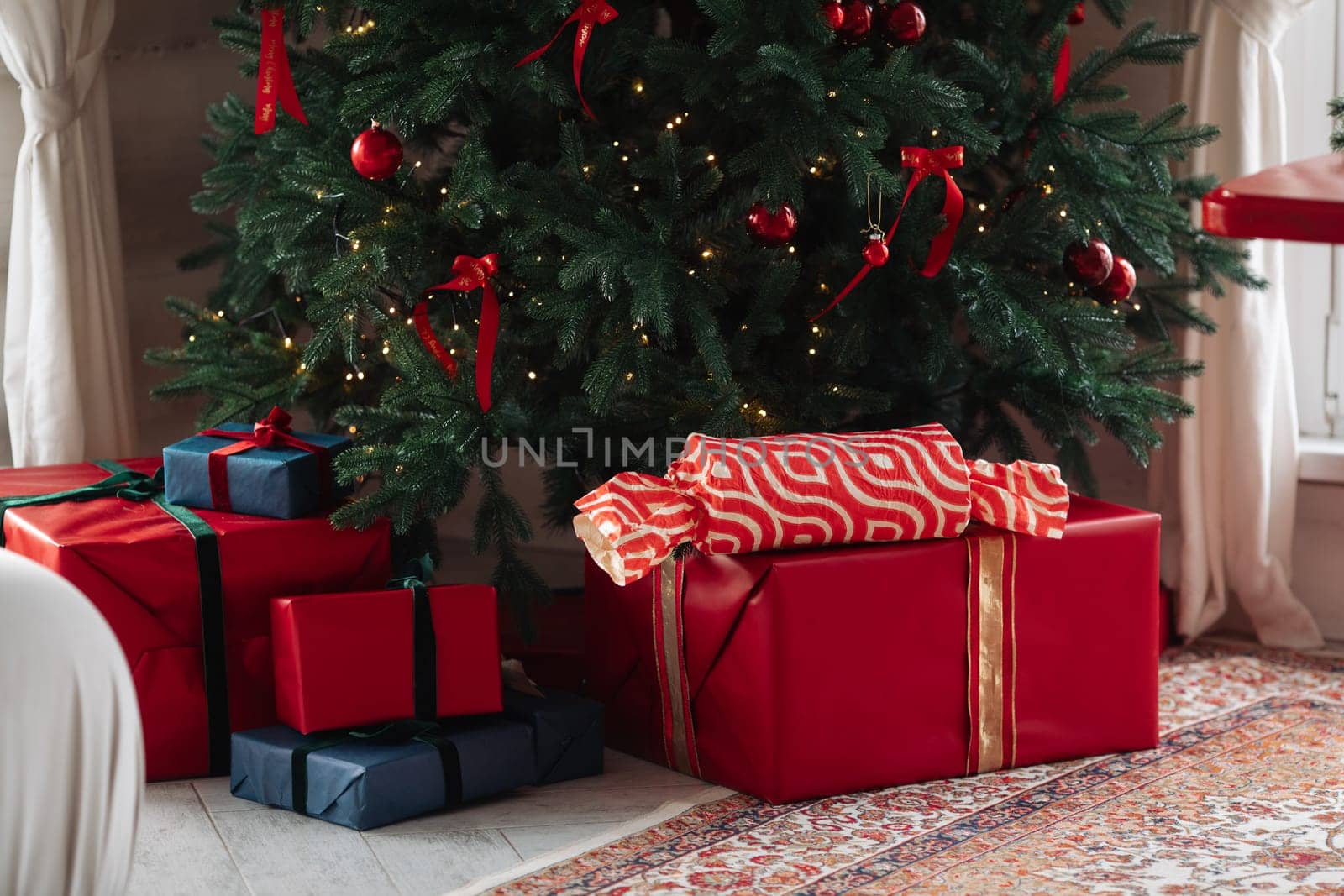 gifts under the tree, lots of gift boxes. Festive mood.