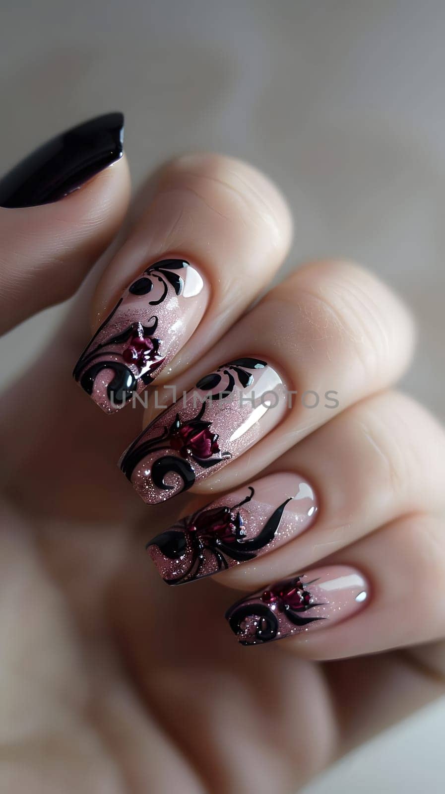 Closeup of a womans nails showcasing an intricate violet nail polish design. The manicure highlights each finger and thumb, emphasizing the artistic gesture of nail care