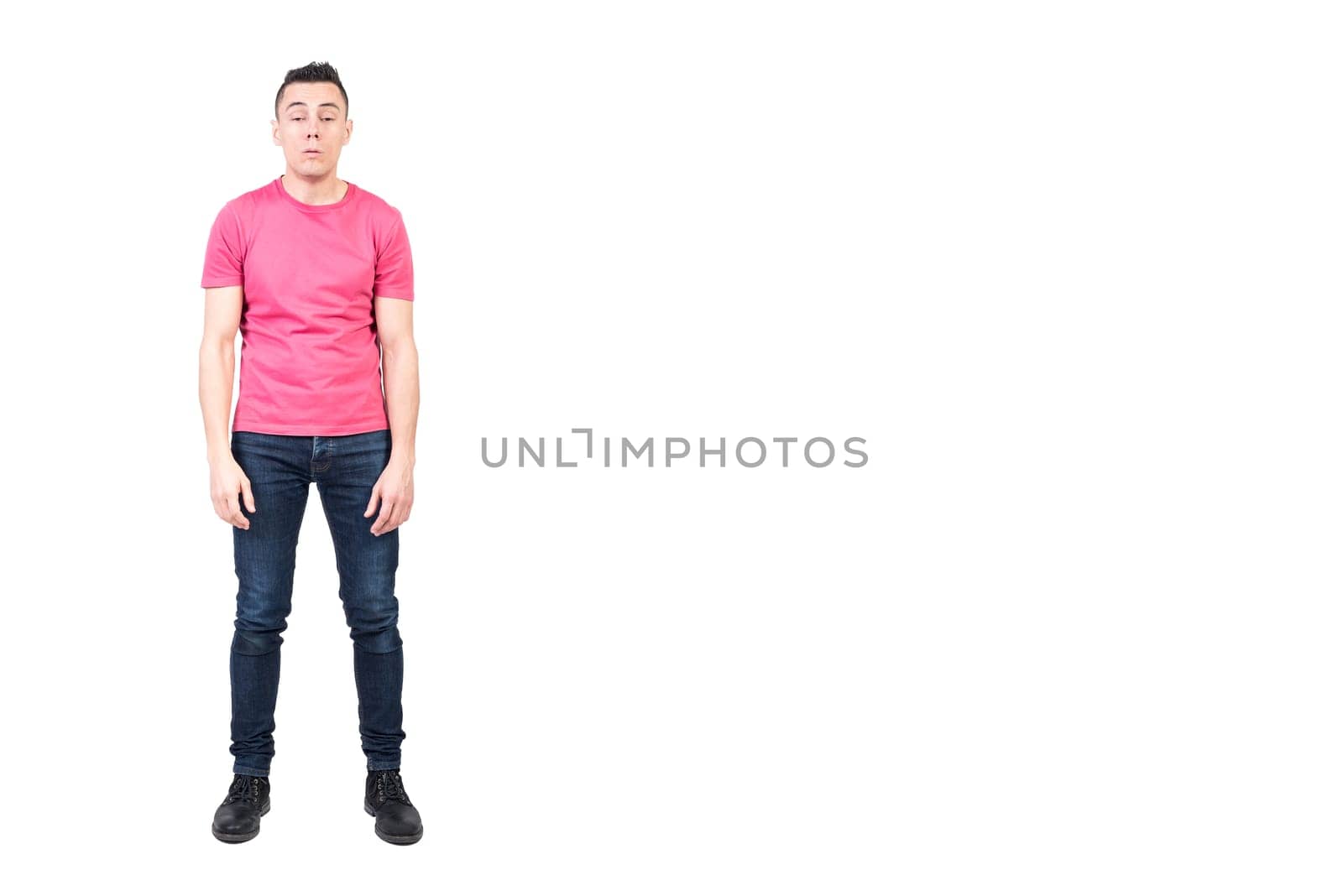 Full body of exhausted sleepy male model in casual clothes woken up early in morning in studio against white background