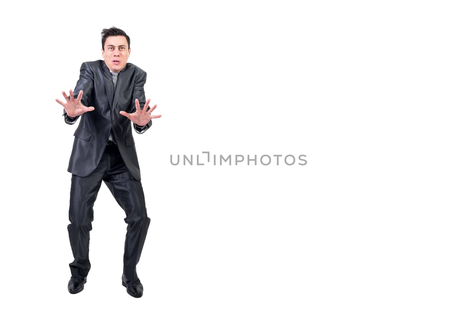 Full body of fearful man in suit showing stop gesture and looking at camera isolated on white background in studio