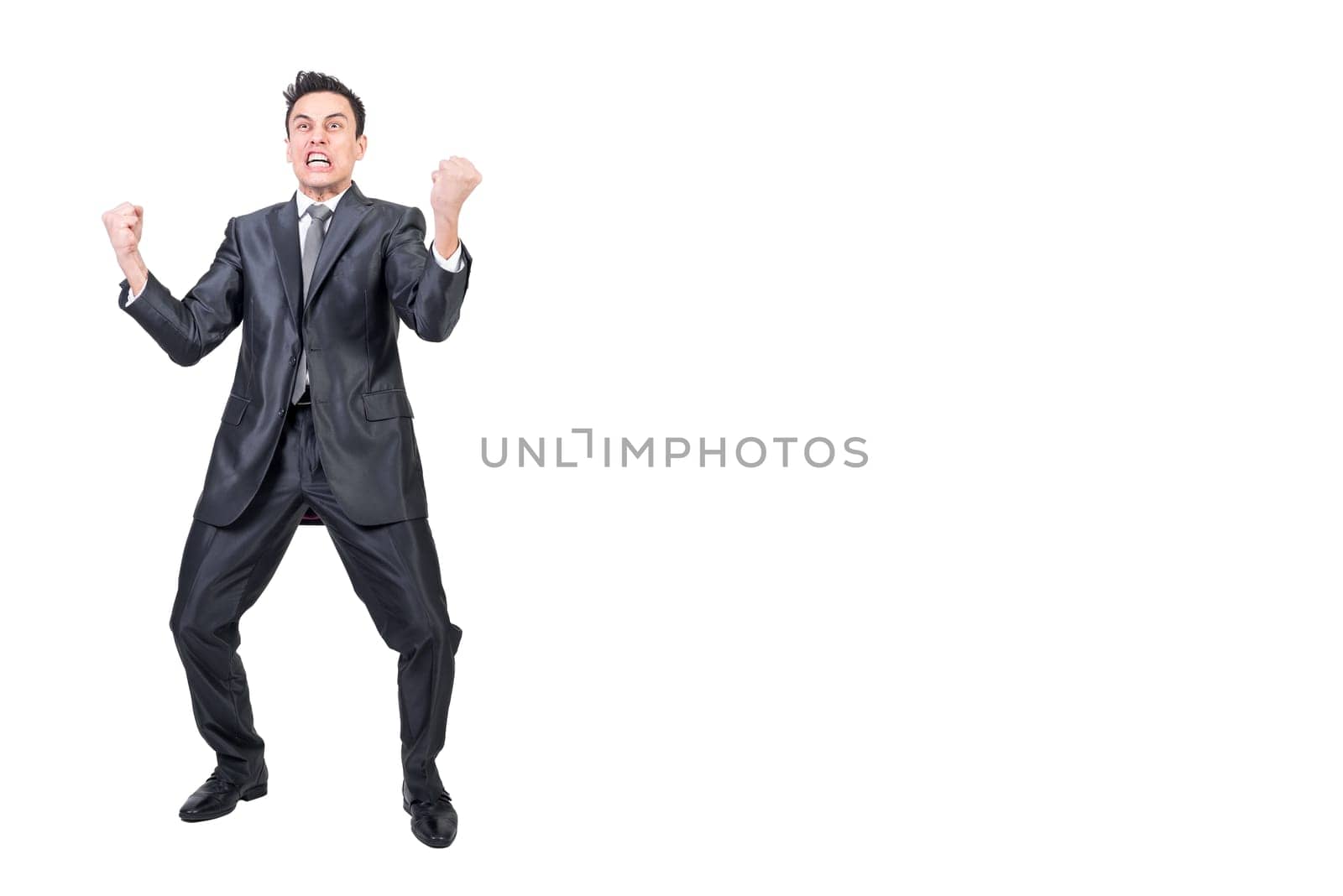 Full body of angry male entrepreneur in classy suit shouting and making face on white background