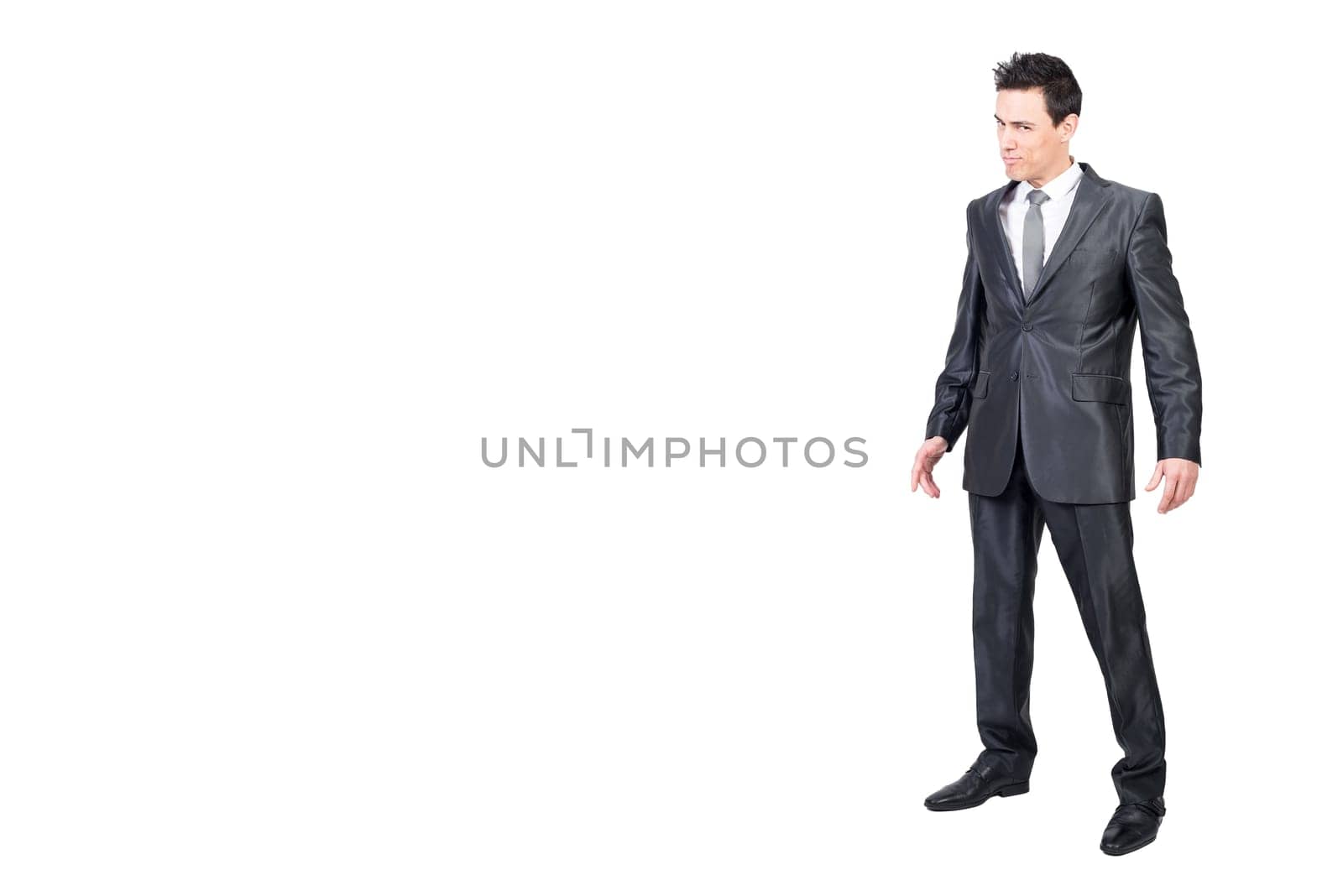 Full body of handsome male in formal outfit looking at camera with seductive face expression isolated on white background in studio