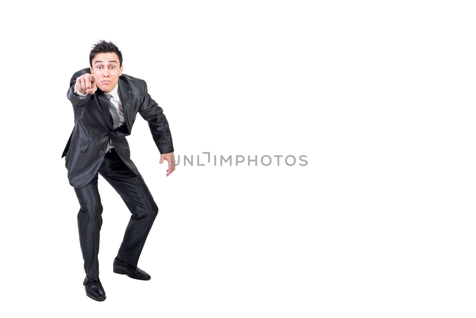 Full body of male in formal suit pointing and looking at camera isolated on white background in light studio