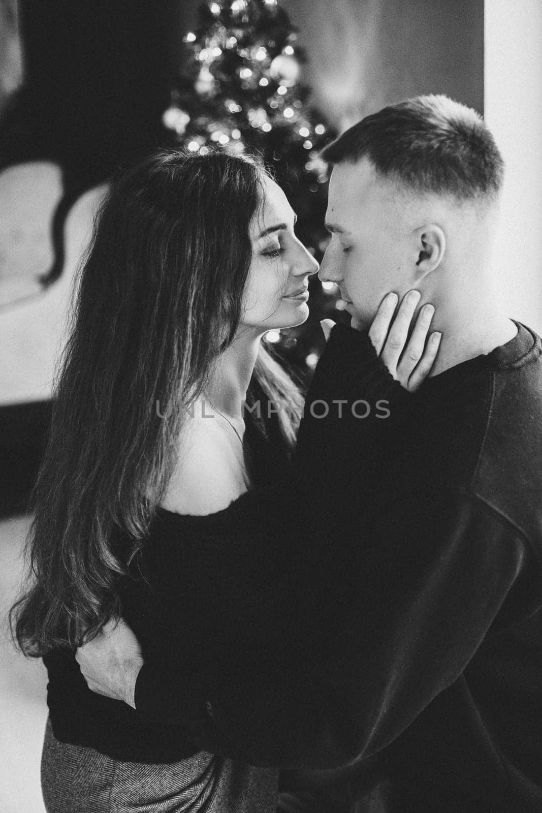 A couple of guys and a girl are beautiful and stylish, in love with the Christmas holiday.