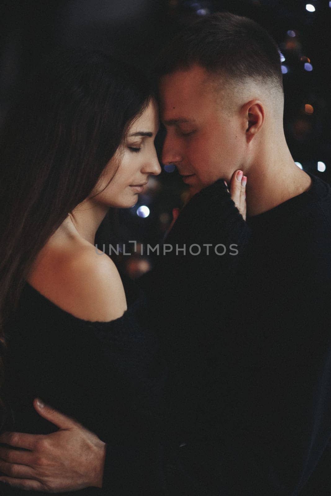 A couple of guys and a girl are beautiful and stylish, in love with the Christmas holiday.