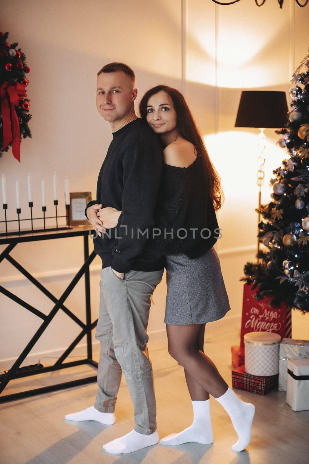 A family around the Christmas tree in the new year, a holiday with family,a beautiful happy stylish family.