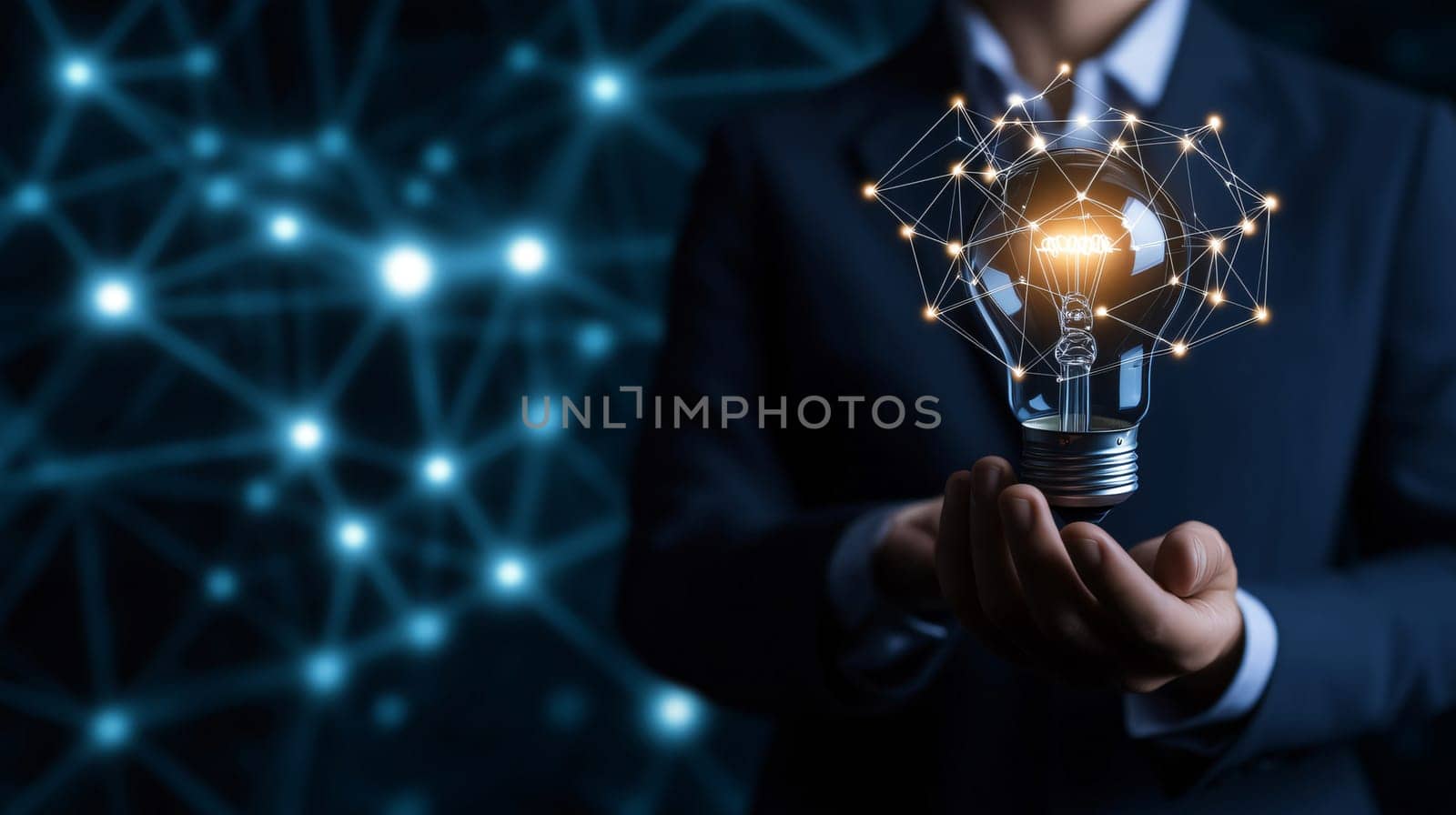 Businessman is holding an illuminated light bulb connected with a network, symbolizing innovation and new ideas