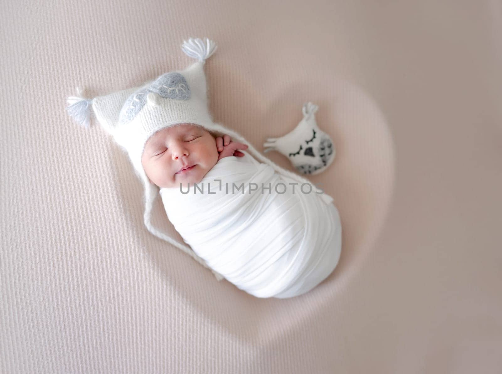 Newborn Baby In Owl Hat Sleeps During Photo Session