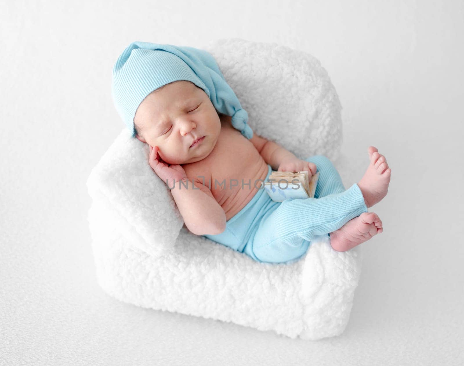 Newborn Baby Sleeps In Chair During Photo Session