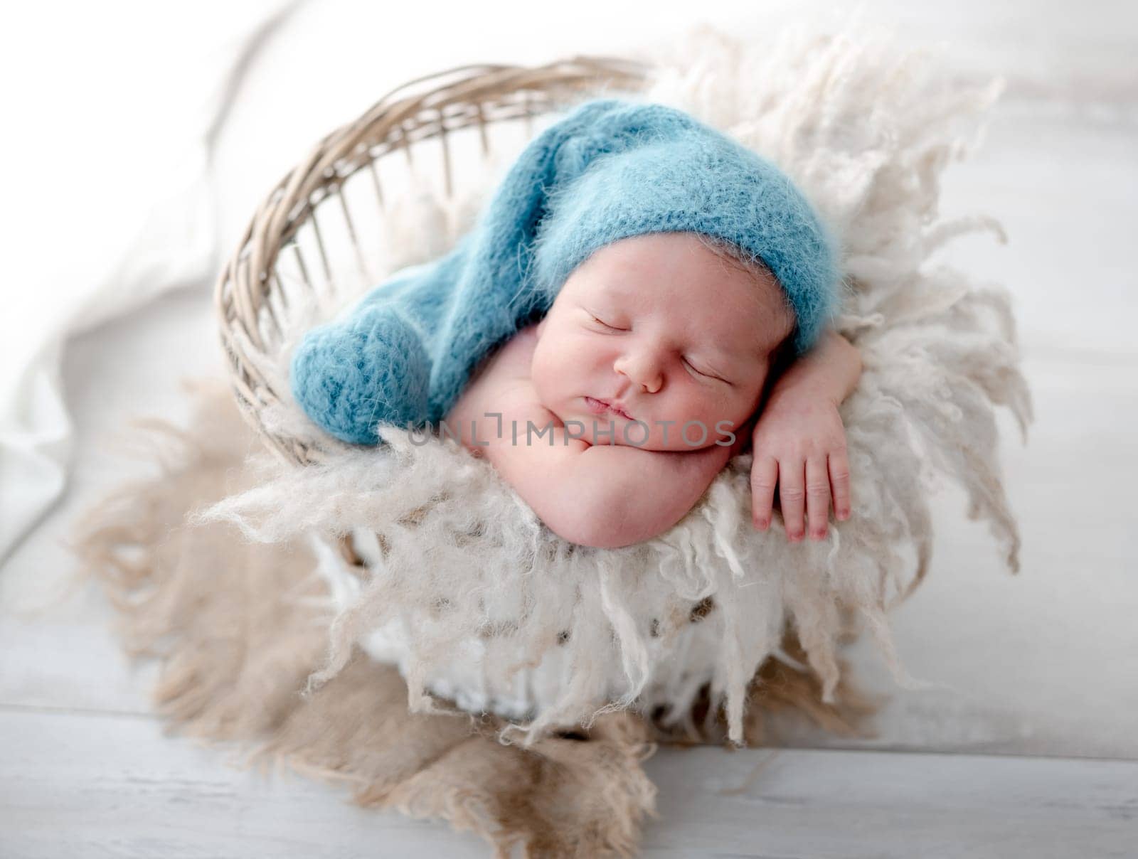 Newborn Baby Sleeps In Basket During Photo Session