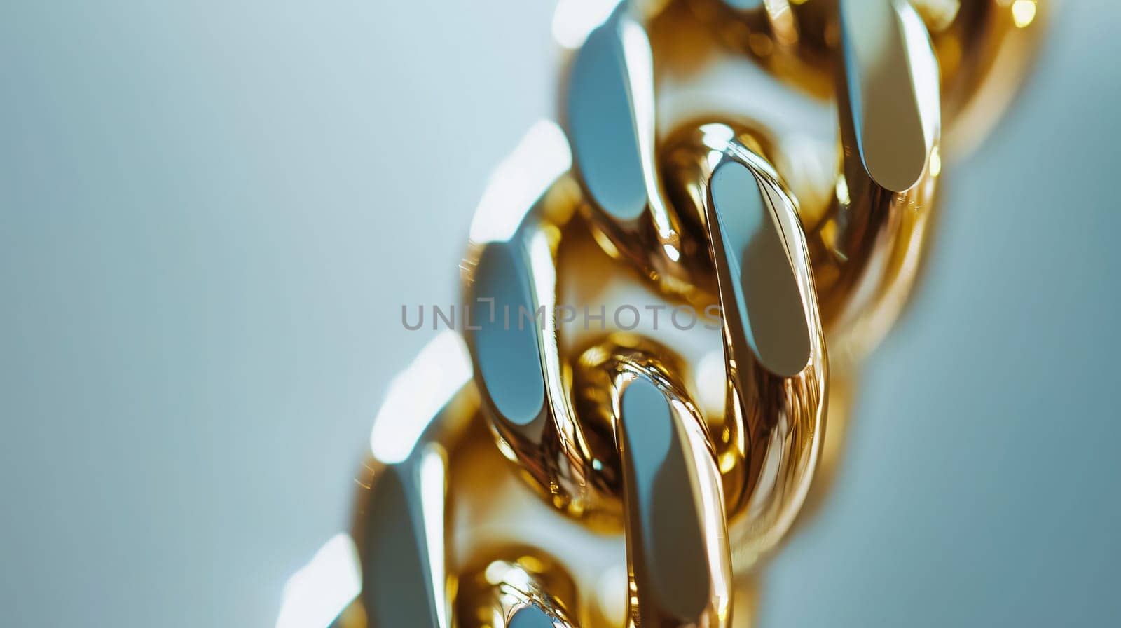 Thick gold chain is laying on a reflective surface, catching the light and creating a luxurious feel