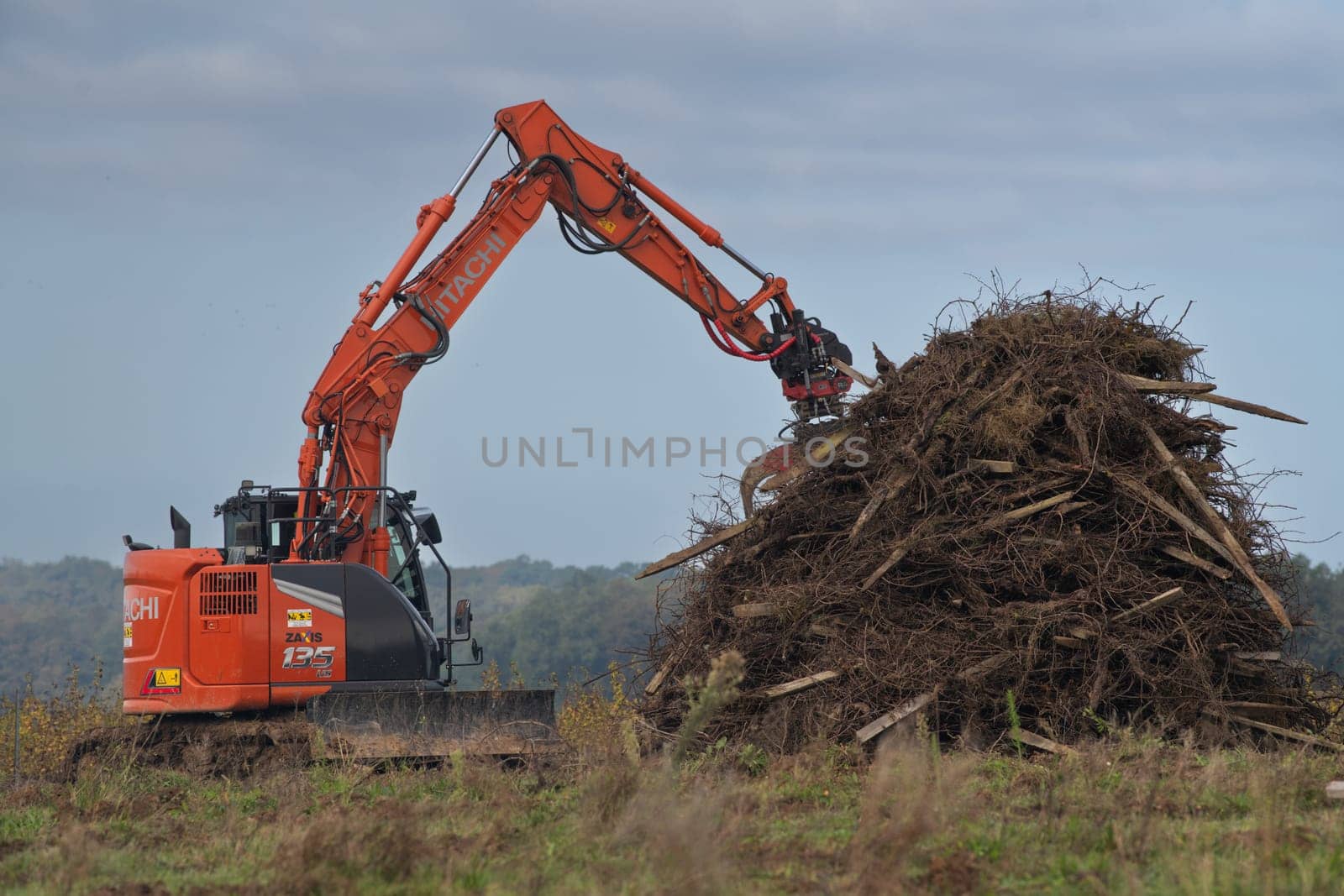 FRANCE, GIRONDE, NAUJAN-ET-POSTIAC, BORDEAUX VINEYARD UPROOTING CAMPAIGN WITH BACKHOE LOADER. High quality photo