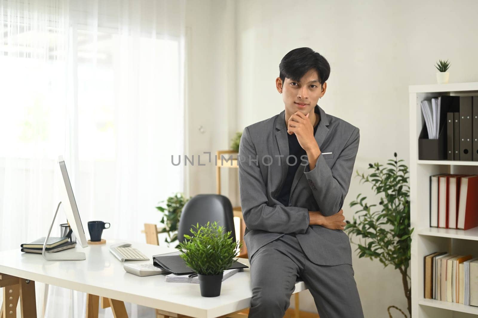 Portrait of confident businessman posing in a modern office.
