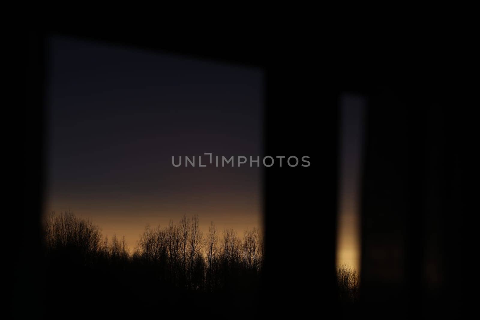 Sunset clouds mirrored in the window. Nature sunset sky backdrop. Blurry abstract sunrise background.