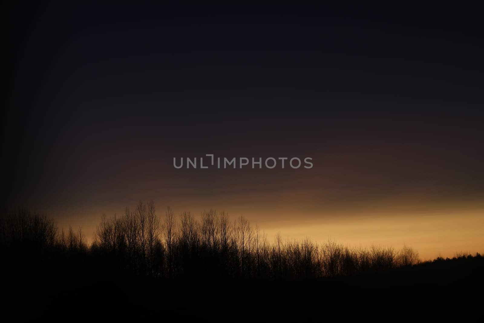 Sunset clouds mirrored in the window. Nature sunset sky backdrop. Blurry abstract sunrise background.