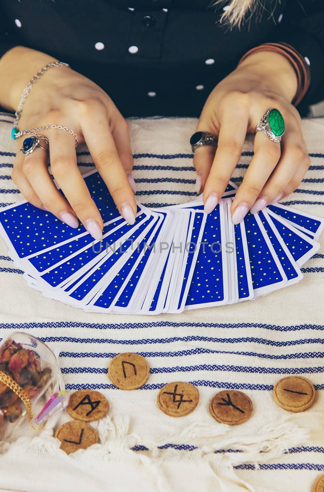 A fortune teller reads with tarot cards. Selective focus. Woman.