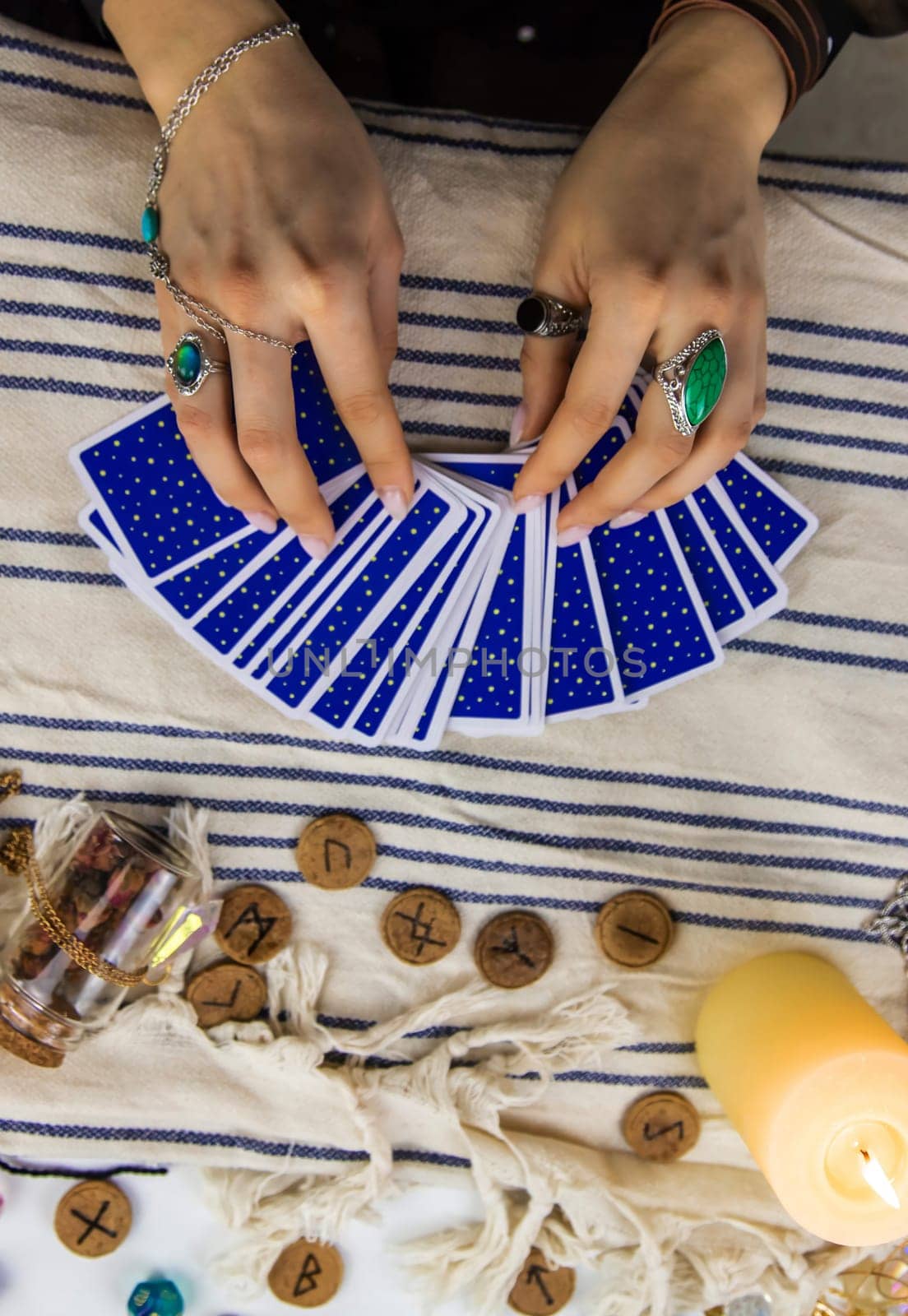 A fortune teller reads with tarot cards. Selective focus. Woman.