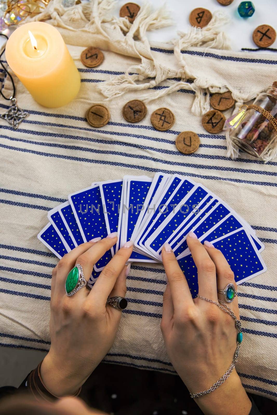 A fortune teller reads with tarot cards. Selective focus. Woman.