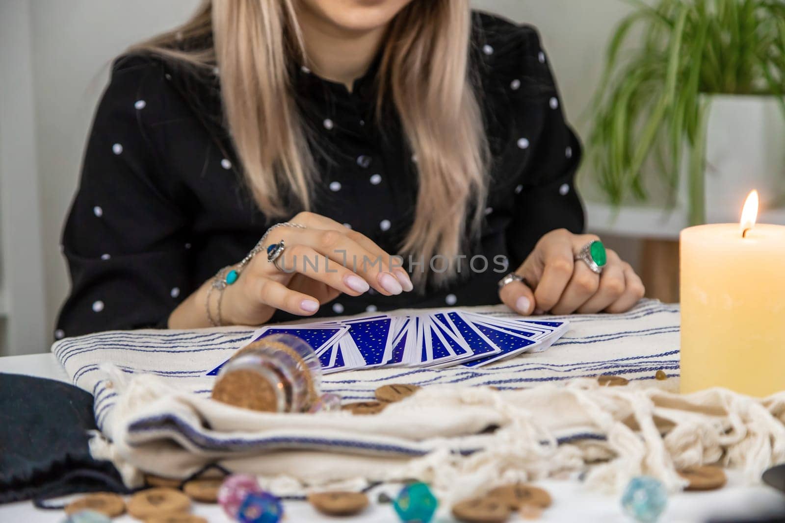 A fortune teller reads with tarot cards. Selective focus. Woman.