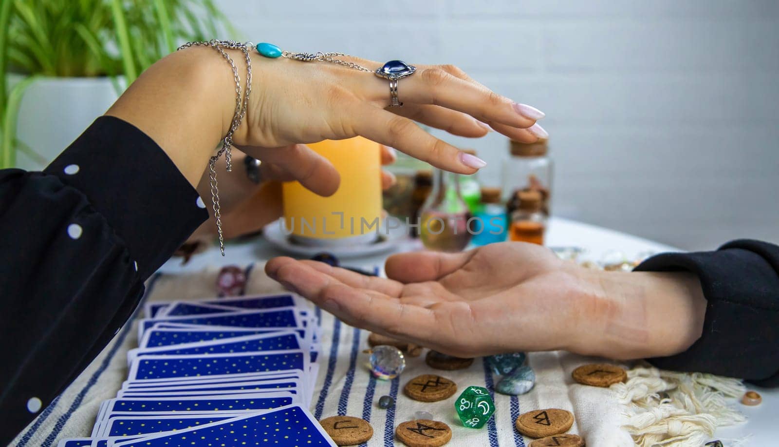 A fortune teller reads with tarot cards. Selective focus. Woman.