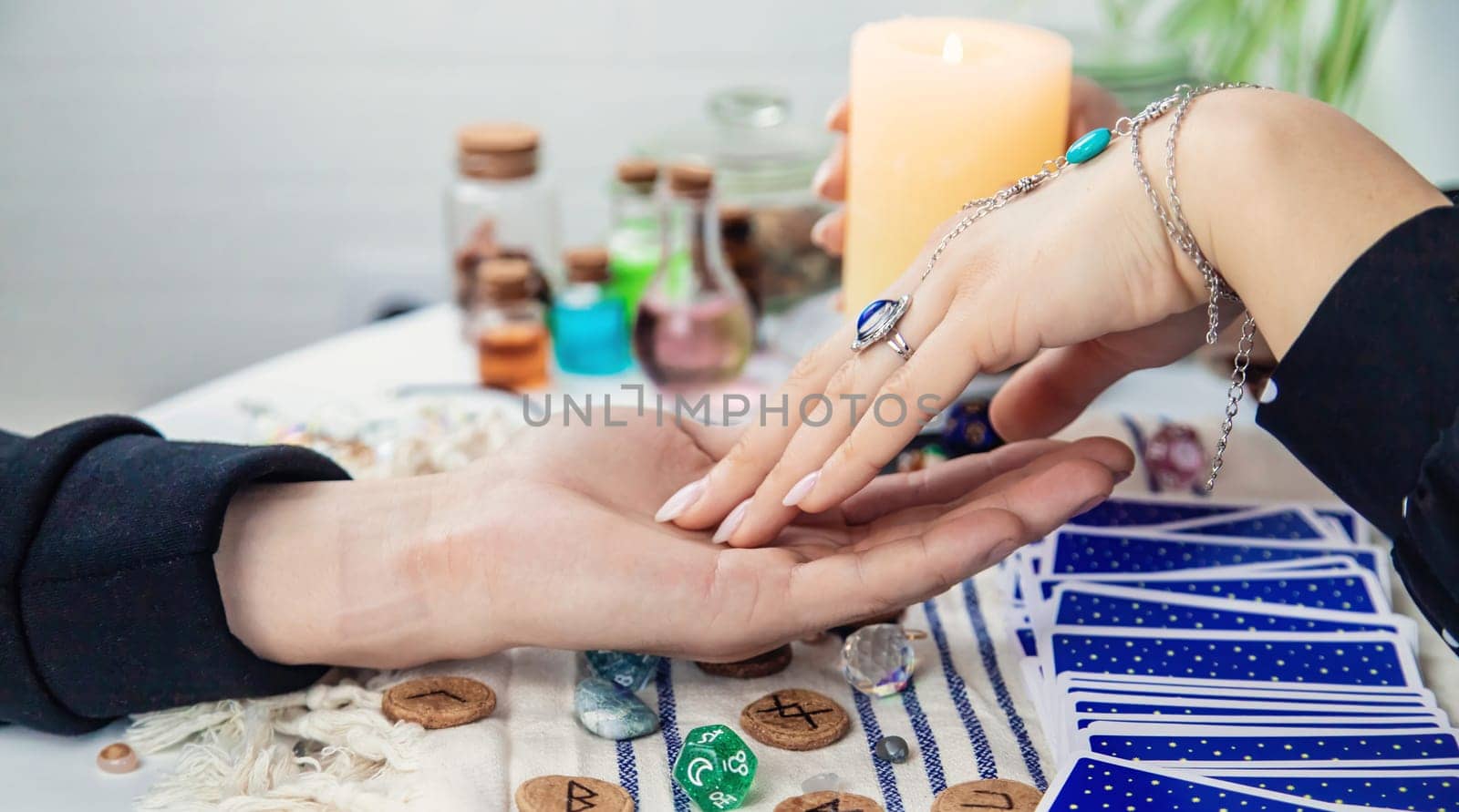 A fortune teller reads with tarot cards. Selective focus. Woman.