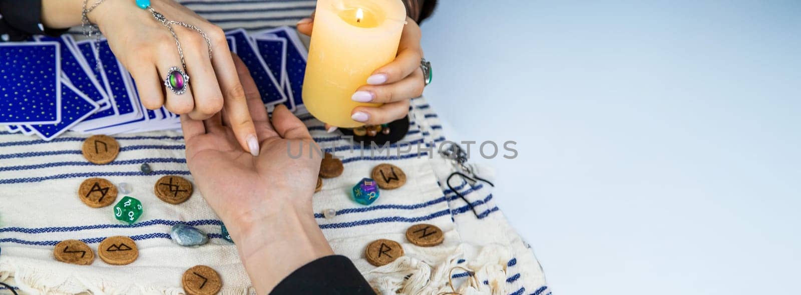 A fortune teller reads with tarot cards. Selective focus. Woman.