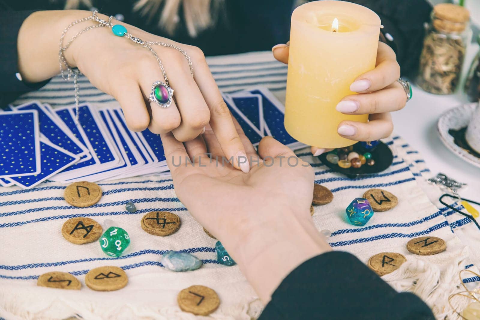 A fortune teller reads with tarot cards. Selective focus. Woman.